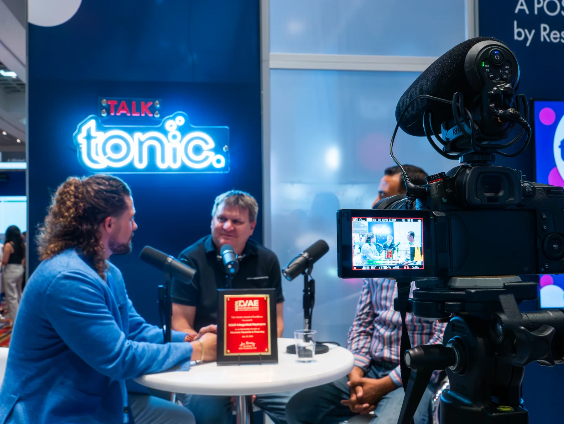 Talk Tonic Recording at RetailNOW Booth Tonic POS CEO Tyler Young recording a Talk Tonic discussion with team leads at the RetailNOW 2024 booth.